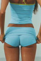 Person wearing a blue athletic outfit against a neutral background