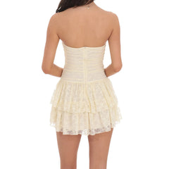 Woman wearing a cream lace dress - back view