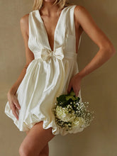 Woman in a white dress holding flowers