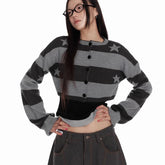 Person wearing a gray and black striped cardigan with star patterns