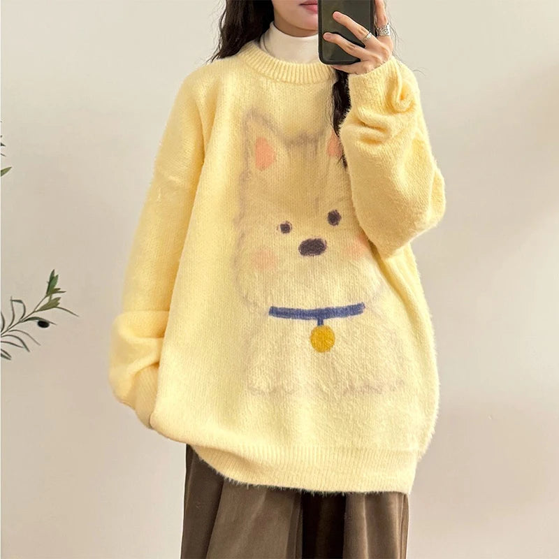 Person wearing a yellow sweater with a cartoon face design against a plain background