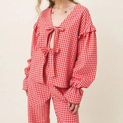 Red and white checkered pajama set on a plain background