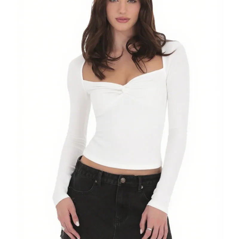 Woman wearing a white long-sleeve top and black pants