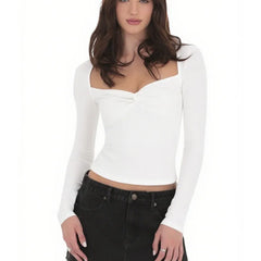 Woman wearing a white long-sleeve top and black pants