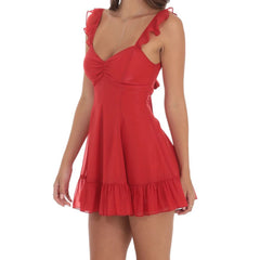 Model displaying a floral print mini dress with ruffles, straps, and an open back.