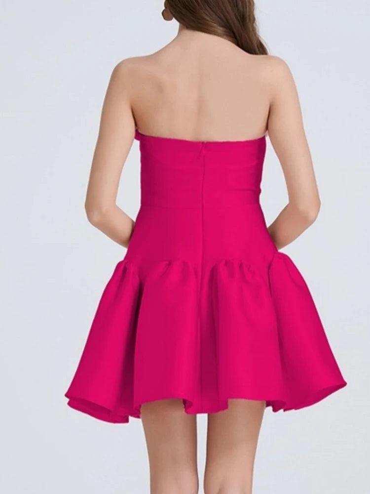 Pink strapless dress on a plain background