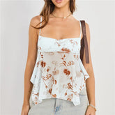 Woman wearing a floral tiered top with a plain background