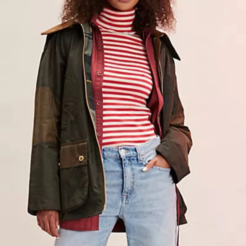 Person wearing a brown jacket, red and white striped shirt, and light blue jeans