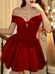 Red off-shoulder dress worn by a person in an indoor setting
