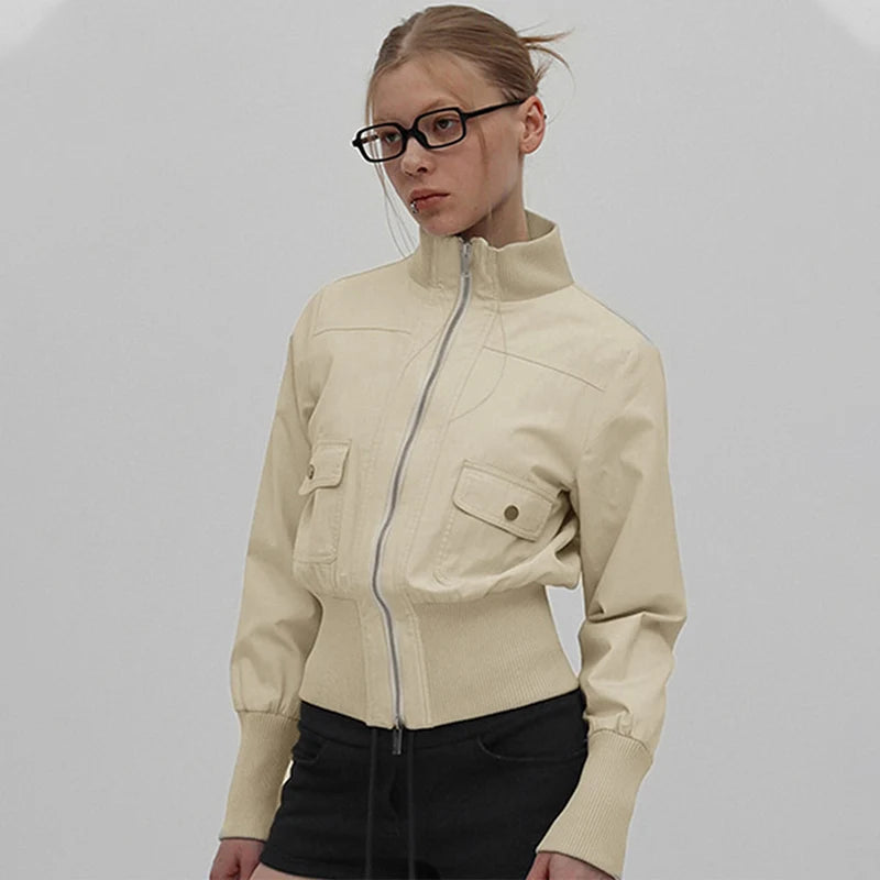 Woman wearing a beige jacket on a plain background