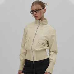 Woman wearing a beige jacket on a plain background