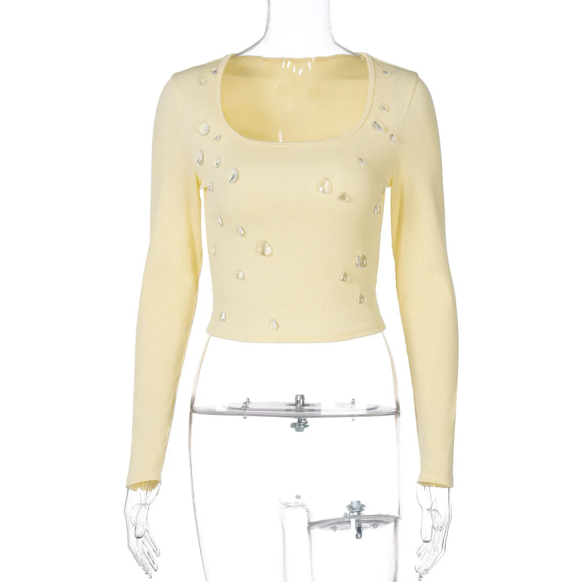 Yellow long-sleeve top with bead embellishments on a mannequin against a white background