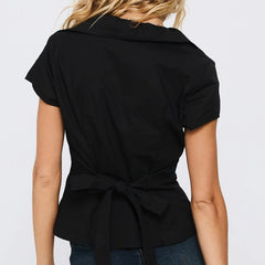 Black short-sleeve blouse with a tie waist worn by a person - back
