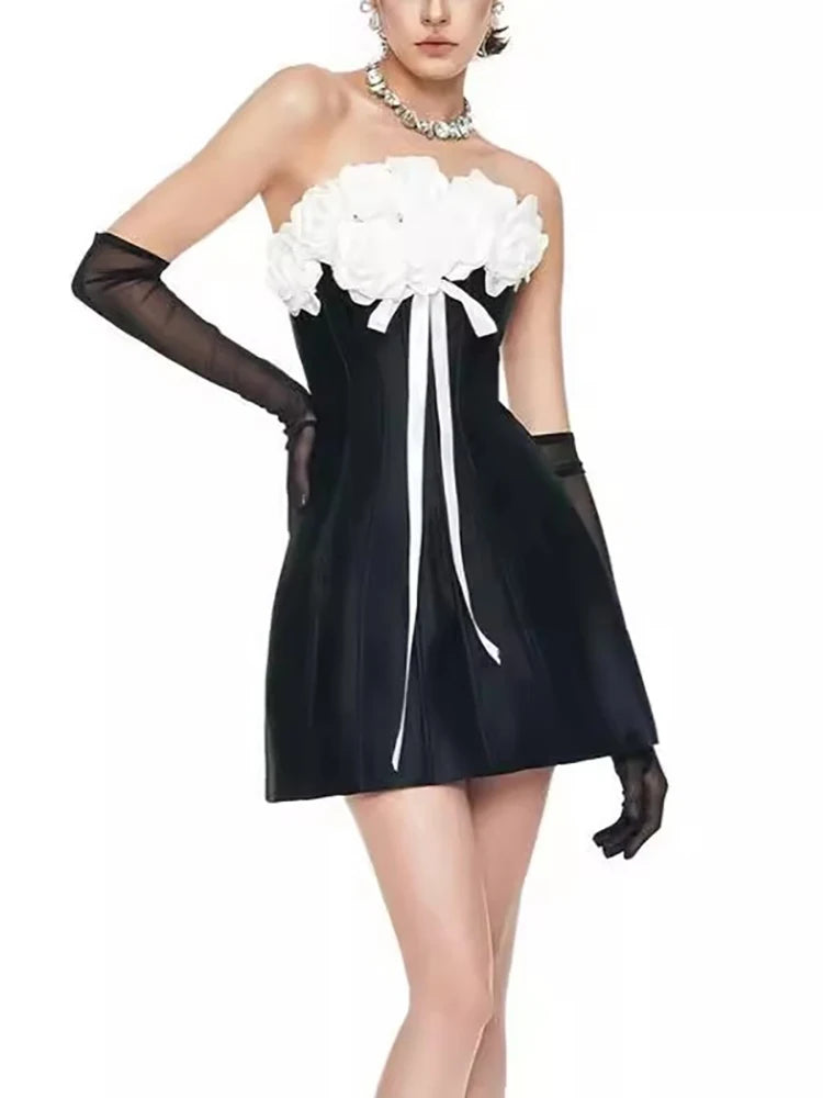 Black strapless dress with white floral details and black gloves
