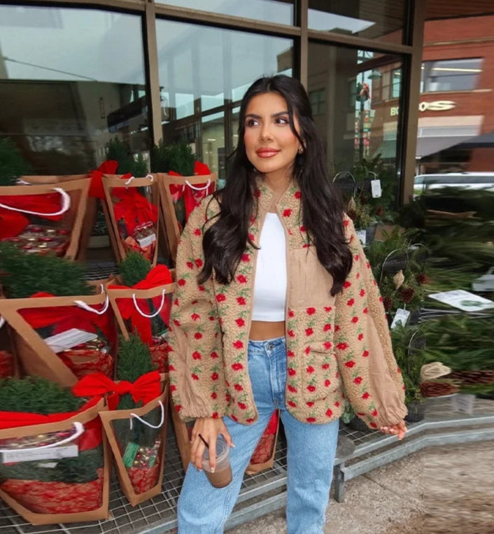Woman standing in front of a store with Christmas decorations