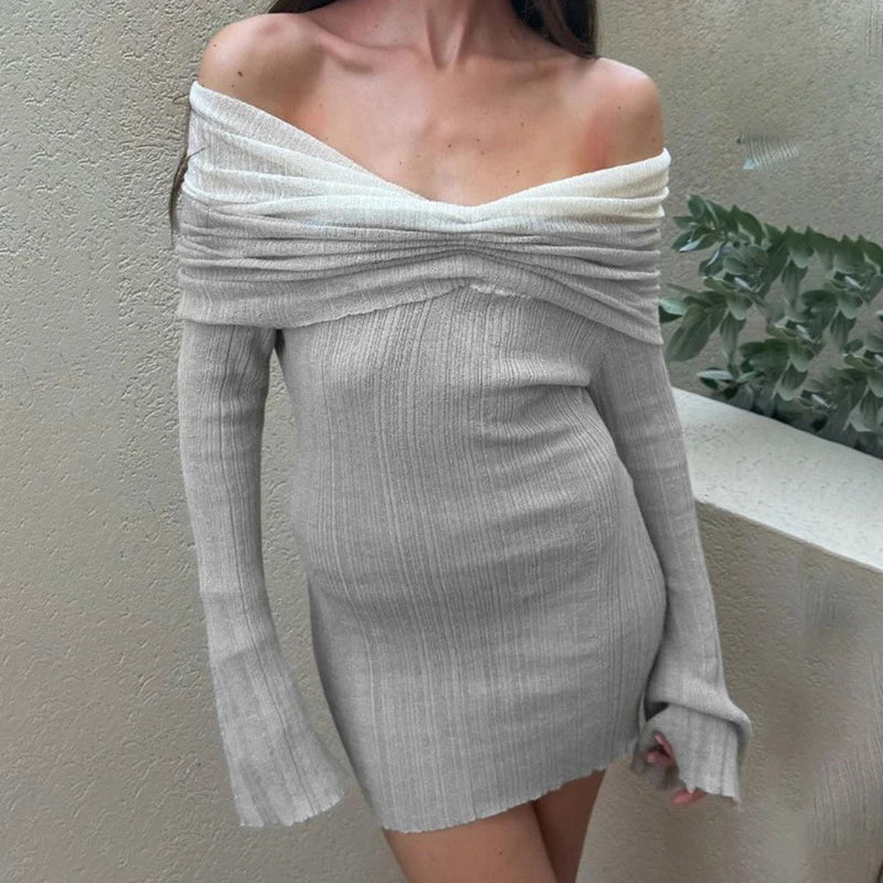 Woman wearing a gray off-shoulder dress against a neutral background