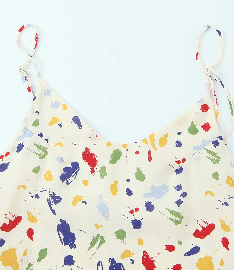 Colorful splatter-patterned top on a white background