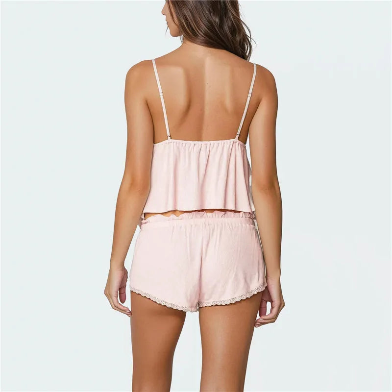 Woman wearing a light pink pajama set on a white background