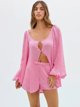 Woman wearing a pink outfit with a cut-out design