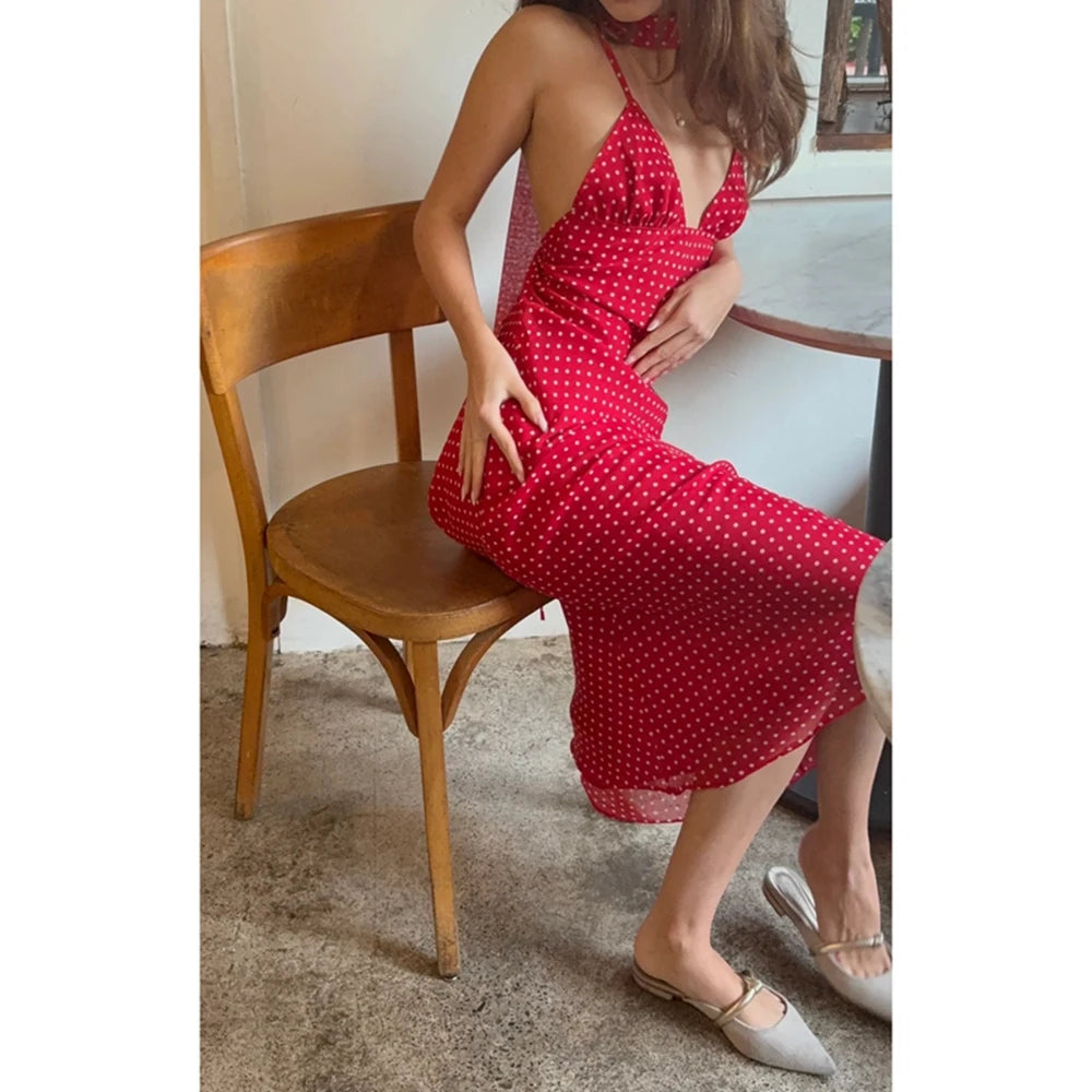 Model displaying a polka dot V-neck long slip dress with spaghetti straps and a matching scarf.