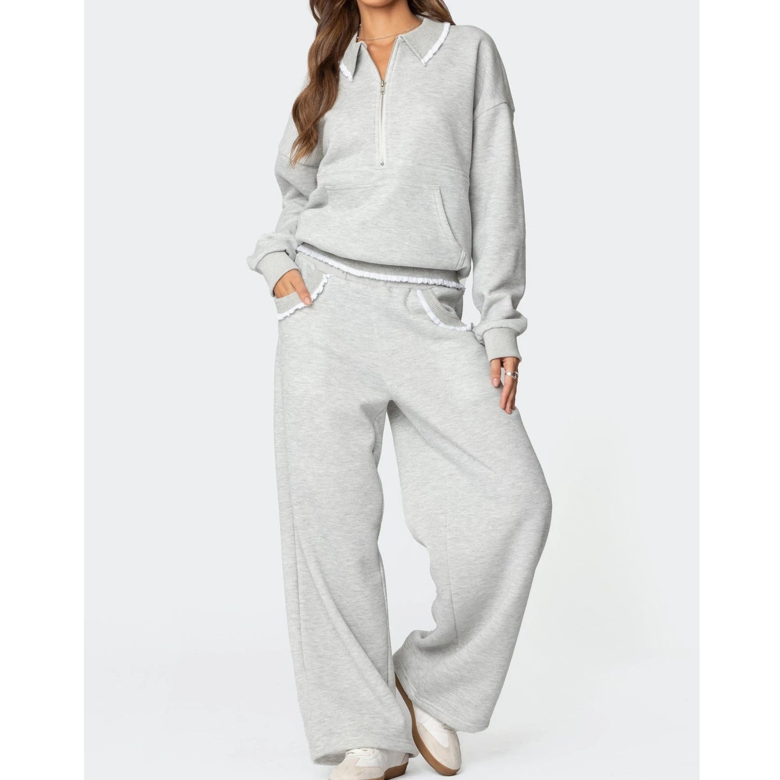 Gray tracksuit worn by a person - full view