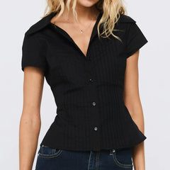 Black peplum top with front buttons worn by a person