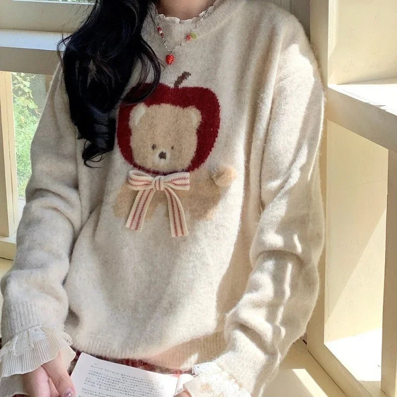 Person wearing a sweater with a teddy bear design in a bright indoor setting