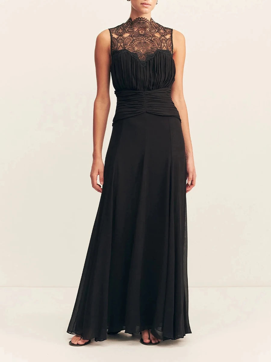 Black evening gown with lace detailing on a white background