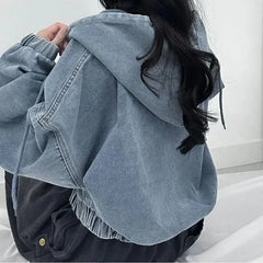 Light blue denim jacket worn by a person with a blurred background