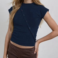 Navy blue top with button details worn by a person on a plain background