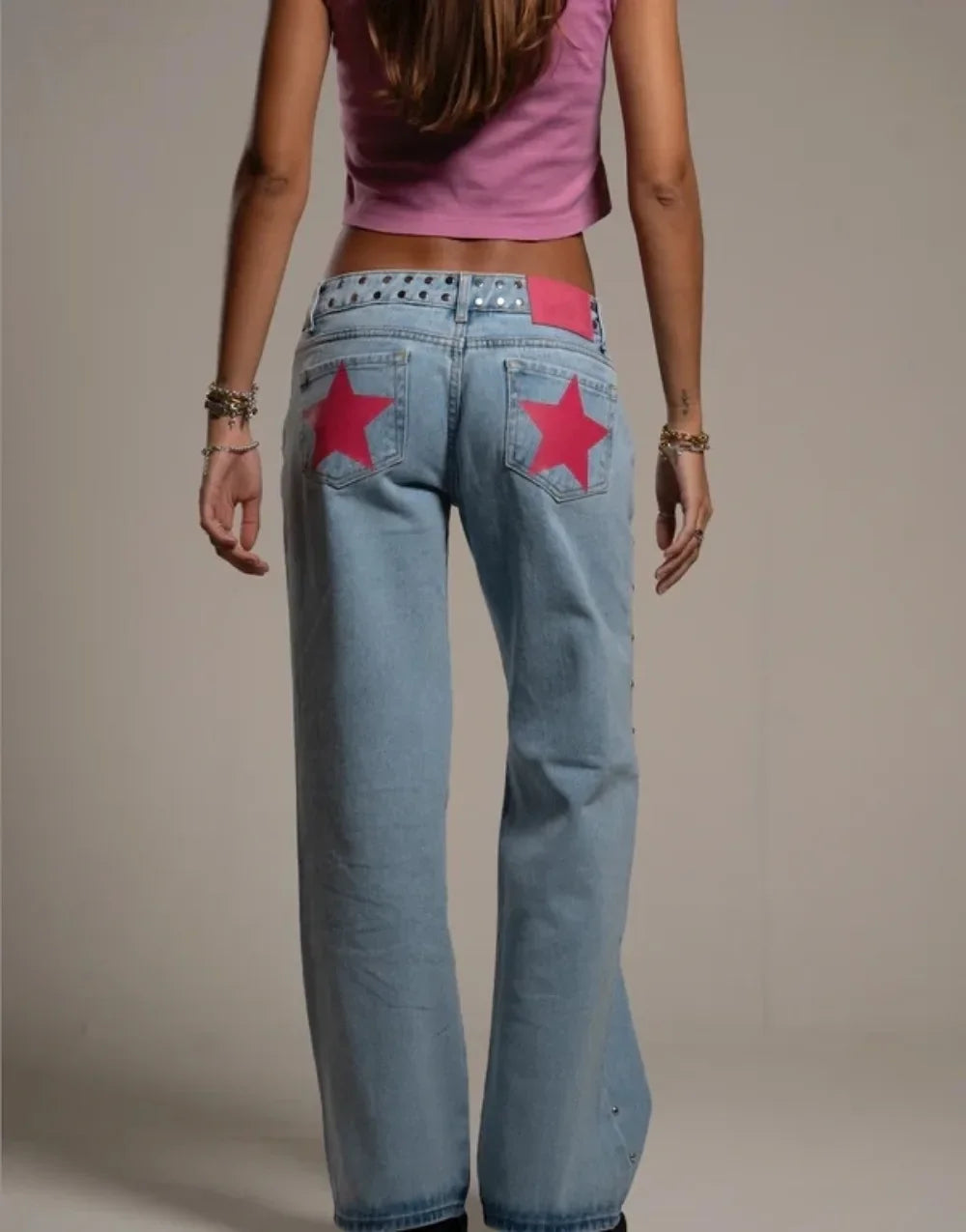 Person wearing light blue jeans with red star