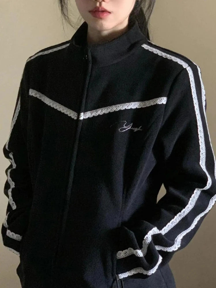 Black tracksuit with white stripes on a plain background
