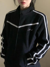 Black tracksuit with white stripes on a plain background