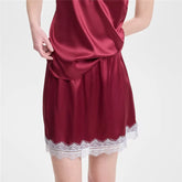 Red satin nightgown with lace trim on a white background