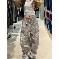 Person wearing a white crop top and patterned pants in a store setting