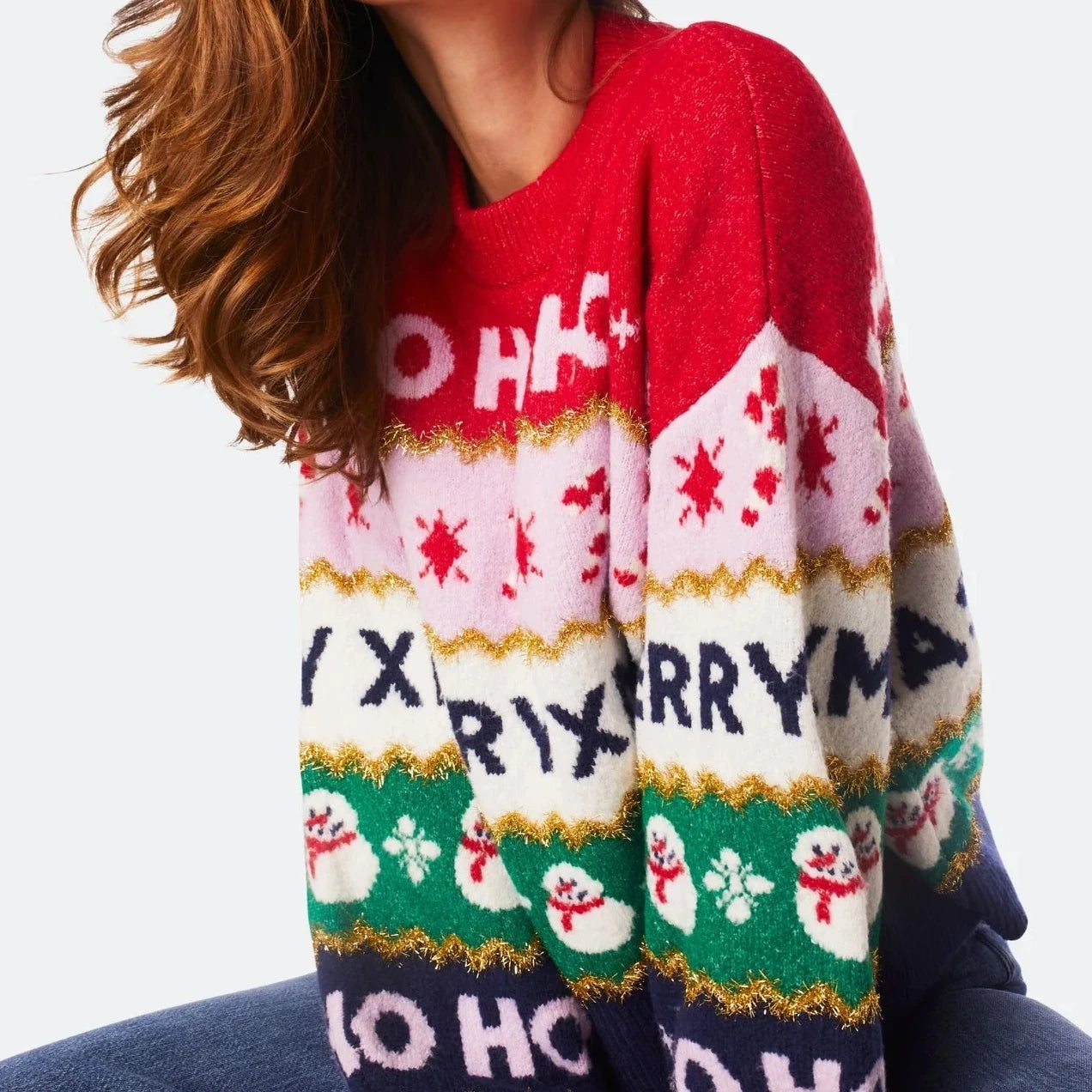 Colorful sweater with festive design and text on a white background