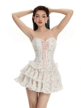 Woman wearing a white floral dress on a white background