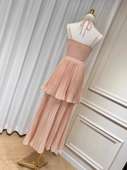 Pink dress on a mannequin against a white curtain background