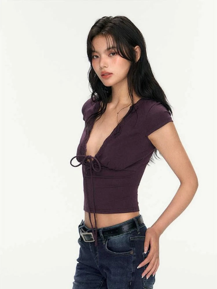 Woman wearing a purple top and blue jeans