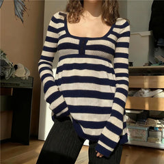 Person wearing a blue and white striped sweater in an indoor setting