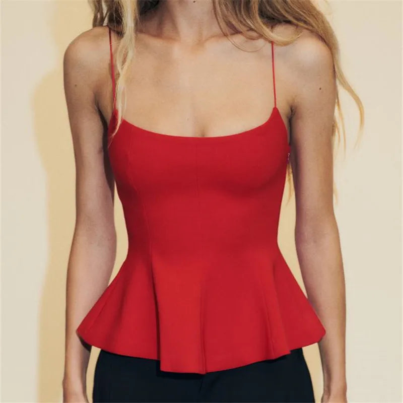 Red peplum top worn by a person on a beige background