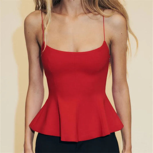 Red peplum top worn by a person on a beige background