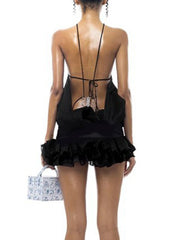 Women's black halter open back mini dress with a vintage sheath style.