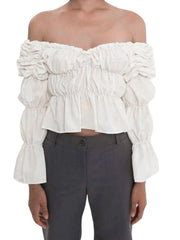 White off-shoulder ruffled top worn by a person