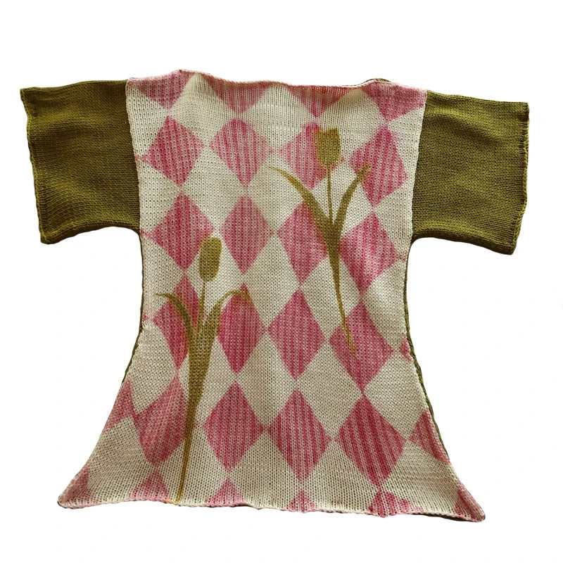 Small fabric dress with pink tulip pattern and green sleeves