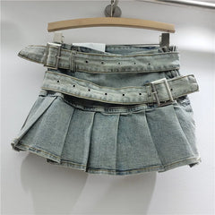 Denim skirt with multiple belts on a hanger against a white background