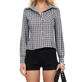 Person wearing a plaid shirt and black shorts