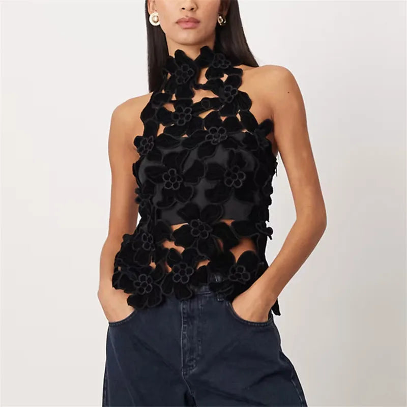 Black floral top worn by a model on a white background