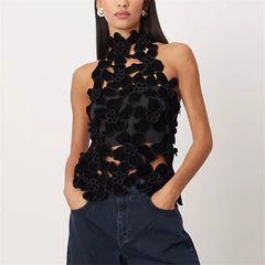 Black floral top worn by a model on a white background