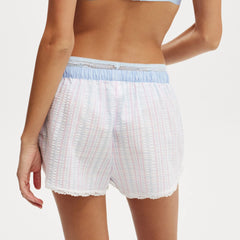 White textured shorts with a light blue waistband on a white background
